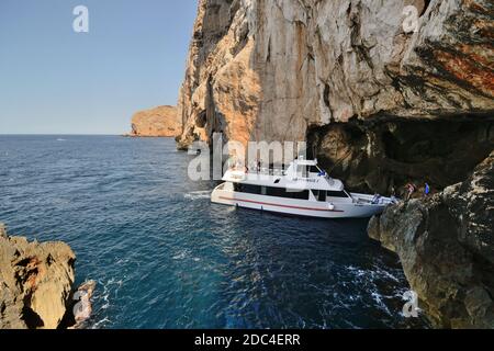 Eine Fähre bringt Touristen in die Neptun-Höhle Das Kap Capo Caccia Stockfoto