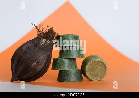 Fünf Bars von ecofriendly hausgemachte ultra feuchtigkeitsspendende grüne harten Balsam oder Seife auf orangefarbenem Hintergrund mit Mohn. Konzept der Öko-Bio-Kosmetik Shop ad Stockfoto