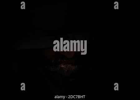 Mann mit einer Kapuze im Dunkeln Stockfoto