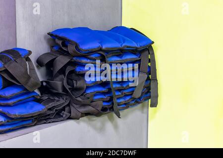Set von blauen Sportgewichte am Handgelenk liegen in Ein Stapel im Fitnessraum Stockfoto