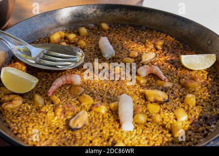 Paella traditionelle Meeresfrüchte spanisch serviert in pan.Close up Ansicht des berühmten Gerichts mit köstlichen Zutaten Garnelen, Tintenfisch, Muscheln, Muscheln, Gemüse Stockfoto