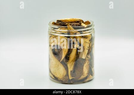 Getrocknete Pilze Lorbeer Bolete in einem Glas Nahaufnahme gegen Weiß Bodengrund Stockfoto