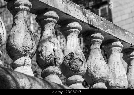 Alte Steinbaluster bei Sonnenstrahlen am Tag in schwarz Und weiß Stockfoto