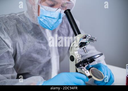 Pharmazeutische Hersteller entwickeln virale Medikamente durch die Erfindung der besten Zutat. Wissenschaftler tragen persönliche Schutzausrüstung mit Gesichtsmaske w Stockfoto