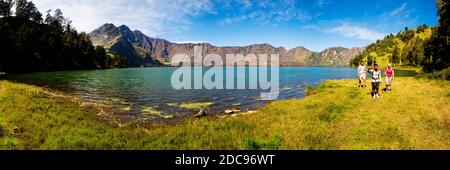 Panorama-Foto von Touristen, die um den Segara Anak See im Mount Rinjani Krater, Lombok, Indonesien, Asien Stockfoto