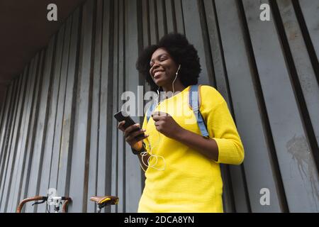 afroamerikanische Frau mit Smartphone auf einer Straße Stockfoto