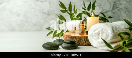 Schönheitsbehandlungen für Spa-Behandlungen auf weißem Holztisch. Massagesteine, ätherische Öle und Meersalz. Kopierraum Stockfoto