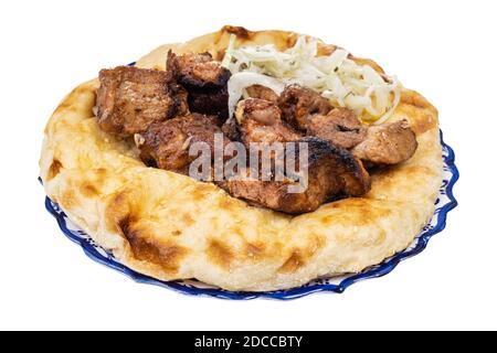 Gegrillter Kebab auf Fladenbrot auf Teller isoliert auf weißem Hintergrund Stockfoto