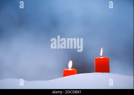 Rote Kerzen im Schnee Stockfoto