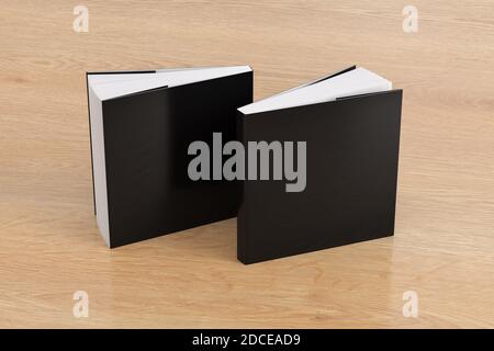 Zwei quadratische schwarze Mockup-Bücher mit Softcover oder Taschenbuch stehen auf dem hölzernen Hintergrund. Leere vordere und hintere Abdeckung Stockfoto