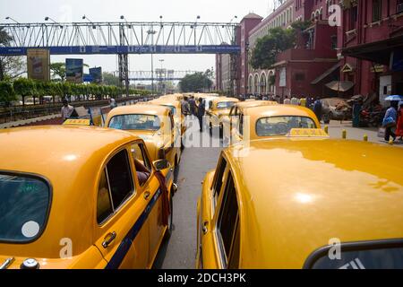 Kolkata, Indien - März 2014: Traditionelle Kalkutta gelb retro Taxis auf dem Parkplatz in der Nähe Howrah Bahnhof warten auf Passagiere bei der Ankunft. Stockfoto