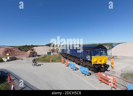 DRS-Lokomotive der Baureihe 66 66091 im Hafenbecken Cavendish, Barrow in Furness mit einem Güterzug, der mit zerkleinerten Zuschlagstoffen beladen wird Stockfoto