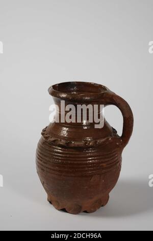 Jug, Anonymous, ca. 1300, Bleiglasur, Steingut, allgemein: 22 x 17.5 x 16cm 220 x 175 x 160mm, Krug mit Griff aus rot gebranntem Steingut mit Bleiglasur. Es hat neun gelappte Beine, einen eiförmigen Körper, einen verengten Hals und einen trichterförmigen Hals. Der Körper hat grob rotierende Ringe und ein gezackter Band auf der Schulter in Relief. Unten ein Etikett: Rodenburch Leiden, 1972 Stockfoto