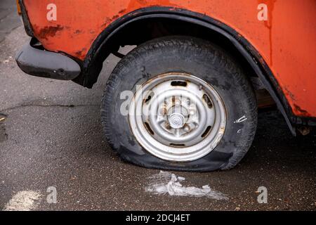 Beschädigte Reifen am Rad eines alten Autos entleeren Stockfoto