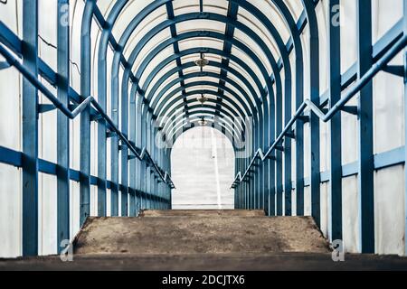 Fußgängerüberweg in der Stadt. Licht durchdringt Kunststofffenster, Metall ist blau lackiert Stockfoto
