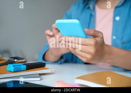 Nahaufnahme des jungen Studenten über die Smartphone-App. Stockfoto