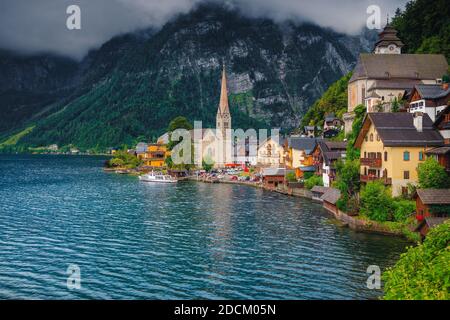 Schönes fabelhaftes Dorf mit spektakulären Häusern und Gebäuden am Ufer des Hallstätter Sees. Atemberaubende Landschaft mit alpinem Dorf und neblig Stockfoto