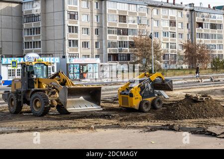 RUSSLAND, ANGARSK - 17. Oktober 2020 Bau, Reparatur einer Straße in einem Wohngebiet der Stadt. Straßenbaumaschinen bei der Konstruktion. Stockfoto