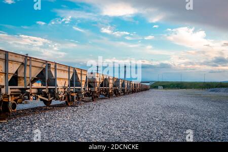 Veraltete Eisenbahnwaggons, verlassen auf alten Eisenbahnschienen. Stockfoto