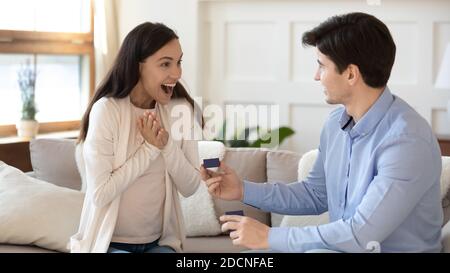 Erstaunt aufgeregt tausendjährigen Freundin erhalten Heiratsantrag von verliebten Freund Stockfoto