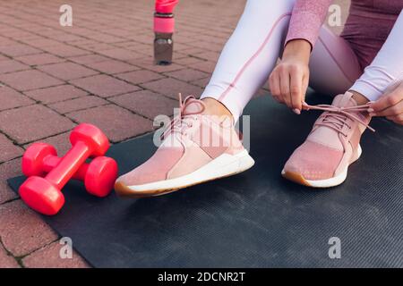 Sport Mädchen binden Schnürsenkel auf Turnschuhe Nahaufnahme Stockfoto