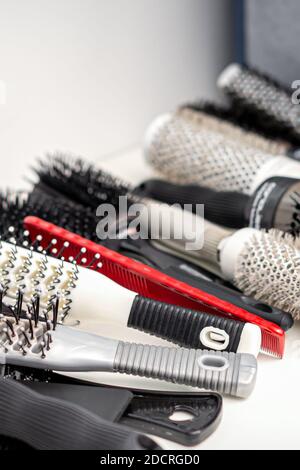 Set mit verschiedenen Haarbürsten und Kämmen, die auf dem liegen Weißer Tisch Stockfoto