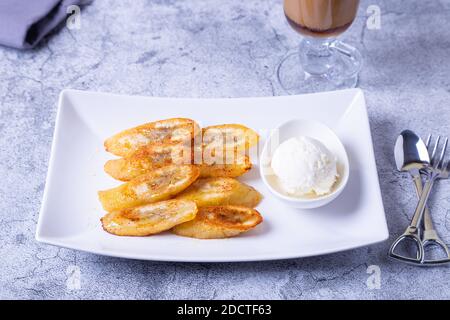 Gebratene Bananen mit Honig, Zimt, Kaffee und Eis. Nahaufnahme. Stockfoto