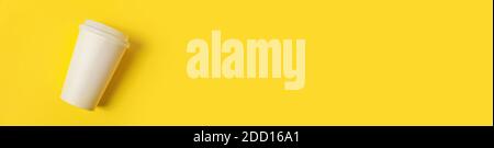 Einfach minimalistisches Design Papier Kaffeetasse auf gelb bunt trendy Hintergrund. Getränkebehälter zum Mitnehmen. Guten Morgen Wake Up Awake Konzept. Vorlage von Stockfoto