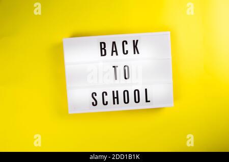 Zurück zur Schule Nachricht auf Leuchtkasten auf gelbem Hintergrund isoliert Stockfoto