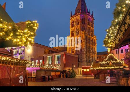 Nachtszene am Rathausplatz in Köln, Deutschland während der Weihnachtszeit, mit dem Weihnachtsmarkt und dem Turm des Rathauses. Stockfoto