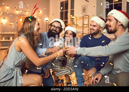 Eine Gruppe von Menschen mit einem Glas Champagner in den Händen feiern gemeinsam das neue Jahr. Stockfoto