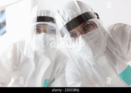 Ansicht von Ärzten in Anti-Pest Schutzanzüge und Bildschirme Im Krankenhaus Stockfoto