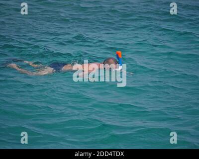 Mann in einer Maske taucht unter Wasser Stockfoto