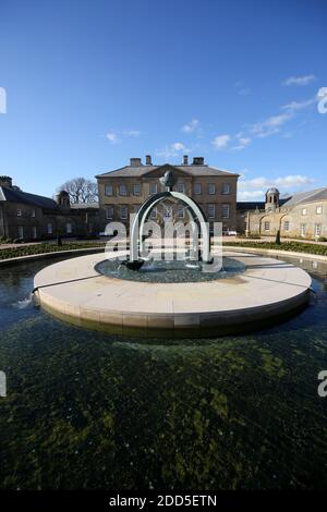 Dumfries House, Cumnock, Schottland, Großbritannien, mit kürzlich installiertem Brunnen an der Vorderseite des Hauses. Der Brunnen, der als Mahfouz-Brunnen bekannt ist. Eine Pest in der Nähe sagt: „Ermöglicht durch die Großzügigkeit von HE Mahfouz Marei Murbank bin Mahfouz. Der Brunnen wurde formell von S.R.H Prinz Charles, Herzog von Rothesay, geöffnet 21. Oktober 2014. Dumfries House ist ein palladianisches Landhaus in Ayrshire, Schottland. Es liegt in einem großen Anwesen, etwa zwei Meilen westlich von Cumnock. Der Brunnen soll im Zentrum eines Skandals um „Cash for Honours“ stehen, bei dem es um die Fürstenstiftung und eine Spende geht Stockfoto