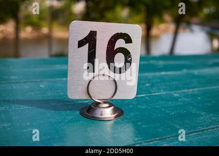 Ein Metallrestaurant, Food Order Number, auf einem grünen Picknicktisch. Nummer 16, in Maine. Stockfoto