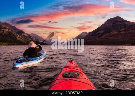 Abenteuerlicher Mann Kajakfahren in Glacier Lake Stockfoto