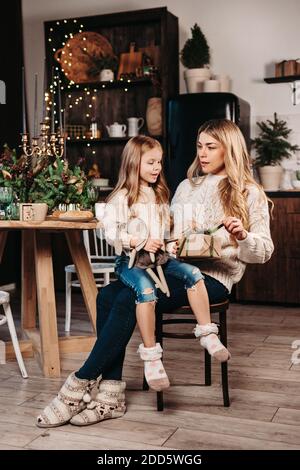 Glückliche Mutter und Tochter Eröffnungsgeschenke an Weihnachten Stockfoto