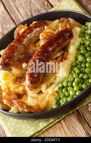 Knaller und Maische mit Zwiebelsoße Nahaufnahme in den Teller auf dem Tisch. Vertikal Stockfoto