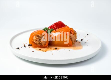Weiße flache Schale mit gefüllter Paprika. Stockfoto