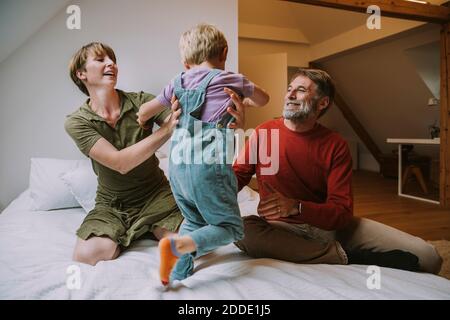 Familie, die Spaß beim Spielen auf dem Bett zu Hause Stockfoto