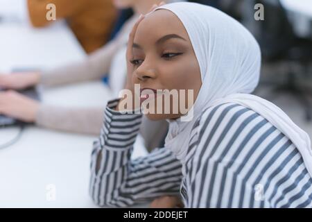 Afrikanische muslimische Geschäftsfrau Gefühl unwohl Leiden von Kopfschmerzen Migräne berühren Stirn während der Arbeit, verärgert schwarze Frau Mitarbeiter frustriert durch Stockfoto