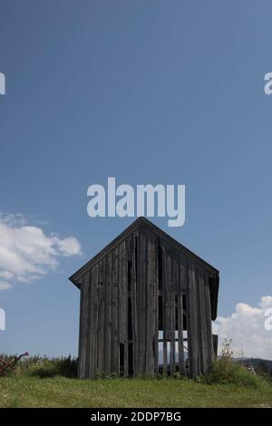 Holzhütte in den alpen, blauer Himmel und Wolken im Hintergrund Stockfoto