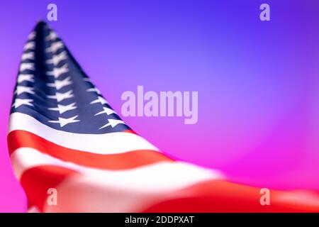 Nahaufnahme der amerikanischen Flagge auf rosa-blauem Hintergrund in Neonlicht. Stockfoto