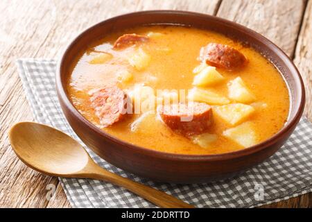Hausgemachte Kartoffelsuppe mit Würstchen und Sauerrahm Nahaufnahme in einem Teller auf dem Tisch. Horizontal Stockfoto
