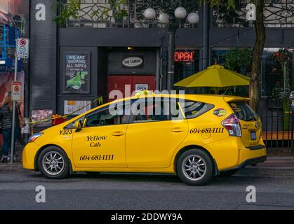 Downtown Vancouver, BC, Kanada - November 1,2020. Gelbes Taxi auf der Straße. Nahaufnahme, selektiver Fokus, Reisefoto, Straßenansicht. Stockfoto