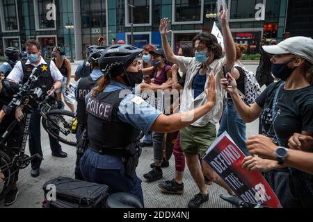 Demonstranten trafen sich am Montagabend auf Chicagos Federal Plaza bei einer Kundgebung für Black Lives Matter und gegen die kürzlich offengelegten Geheimpolizei-Initiativen von Präsident Trump. Die Demonstranten führten einen marathonmarsch durch die Innenstadt von Chicago durch, stoppten den Verkehr an wichtigen Kreuzungen und Brücken mehrmals und prallen mehrmals auf dem Weg mit dem Polizeifahrradkommando, das sie durch die belebten Straßen begleiteten. Stockfoto