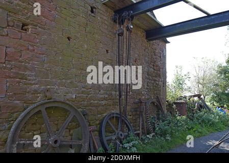 Ein Paar große Kettenzüge auf einem großen Stahlträger, der zwischen zwei Scheunen auf einer Farm in Cumbria, Großbritannien, hängt Stockfoto