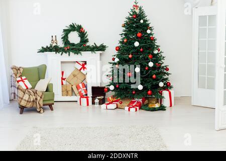 Weißes Zimmer weihnachtsbaum Kiefer Kamin mit Neujahr Dekoration Geschenke Stockfoto