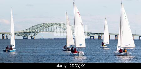 Babylon, New York, USA – 7. Dezember 2019: Zwei-Personen-Segelboote bei einer Winterregatta mit der Great South Bay Bridge im Hintergrund auf Long Island Ne Stockfoto