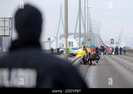 Hamburg, Deutschland. November 2020. Polizeikräfte und Aktivisten stehen auf der Köhlbrandbrücke im Hamburger Hafen. Die Hamburger Köhlbrandbrücke wurde am Freitagmorgen von rund 40 Anhängern der Umweltschutzbewegung Extinction Rebellion blockiert. Einige Aktivisten haben sich mit Stahlrohren an die Brücke gekettet. (To dpa 'Aktivisten lähmen Autobahnen in mehreren Bundesstaaten'= Quelle: Bodo Marks/dpa/Alamy Live News Stockfoto